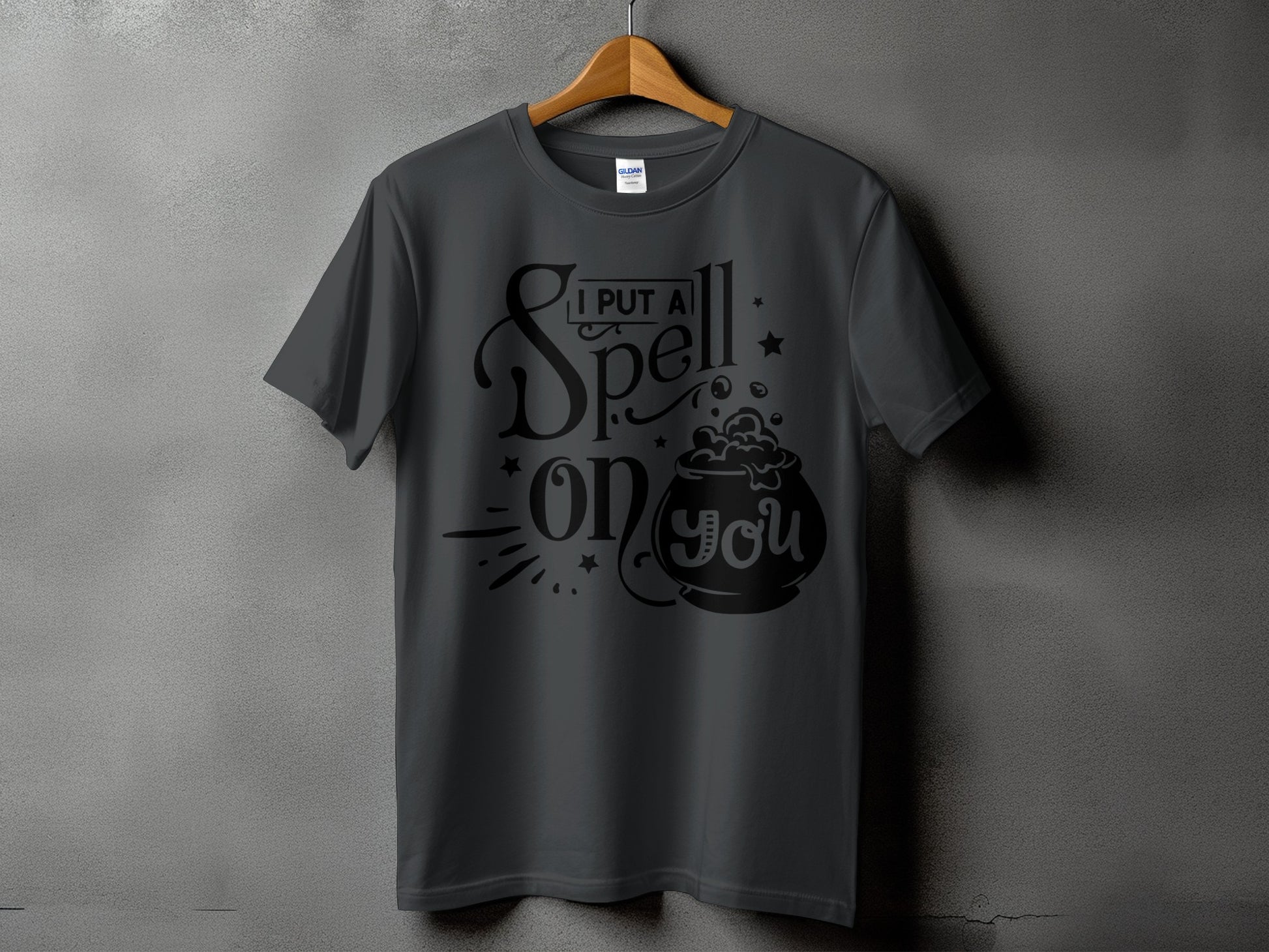 Dark gray t-shirt with "I PUT A Spell on you" text and cauldron graphic.