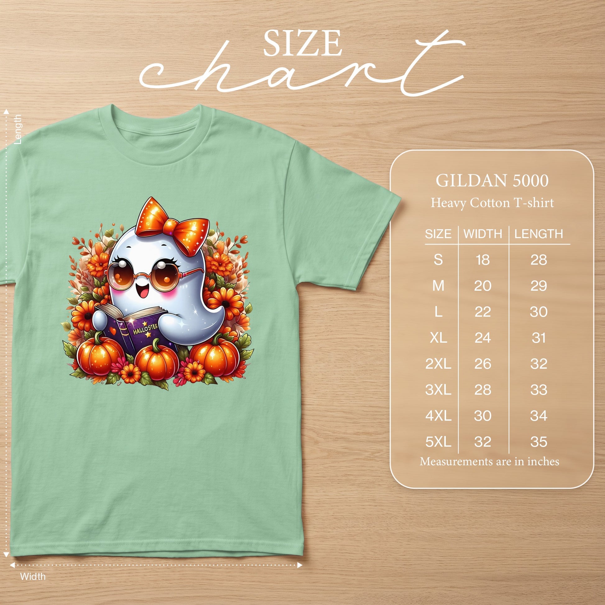 Light green t-shirt with cartoon ghost reading a book, pumpkins, and flowers, with size chart.