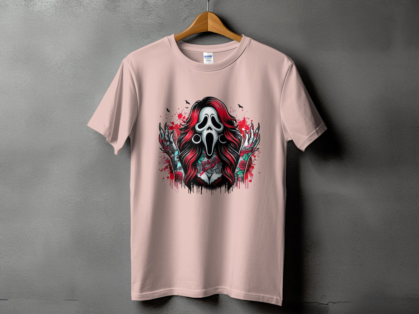 Pink t-shirt with a graphic of a screaming ghost mask and tattooed torso.