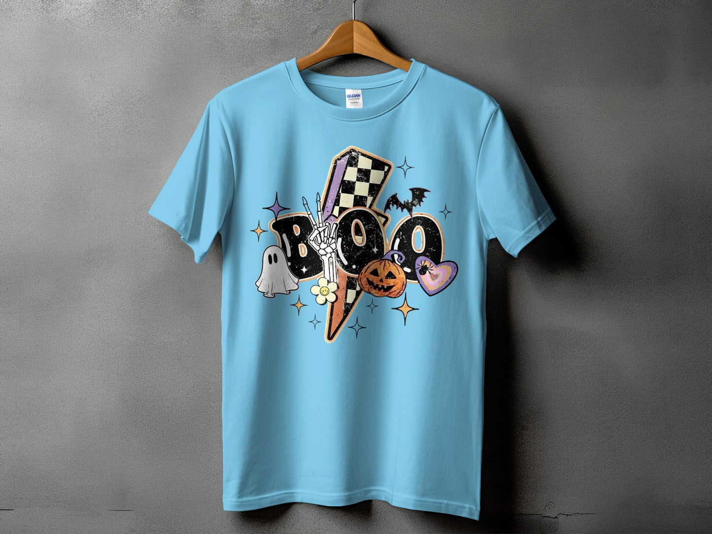 Light blue t-shirt with "BOO" text featuring Halloween graphics and a skeleton hand.