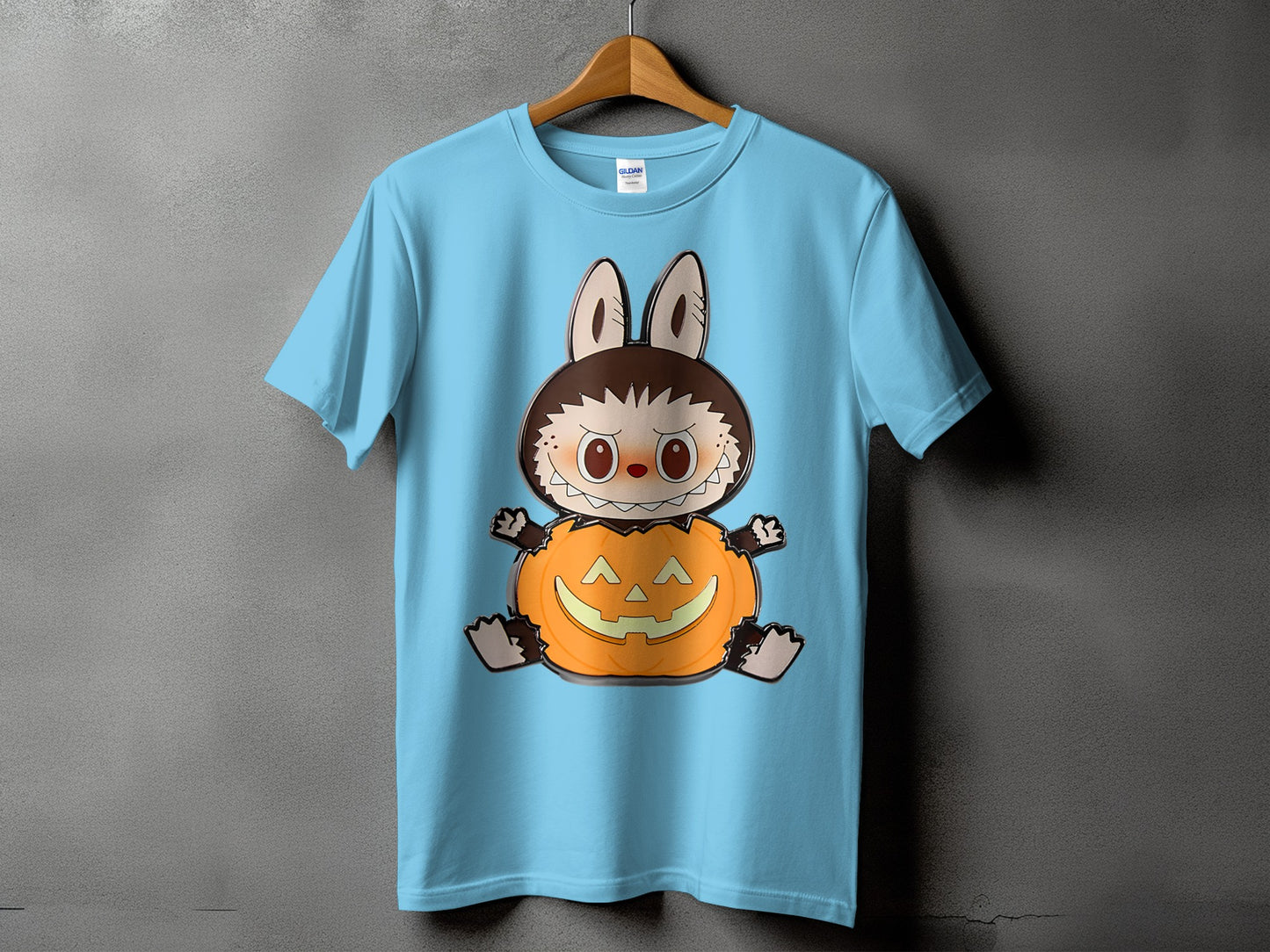 Light blue t-shirt featuring a cartoon character in a pumpkin costume.