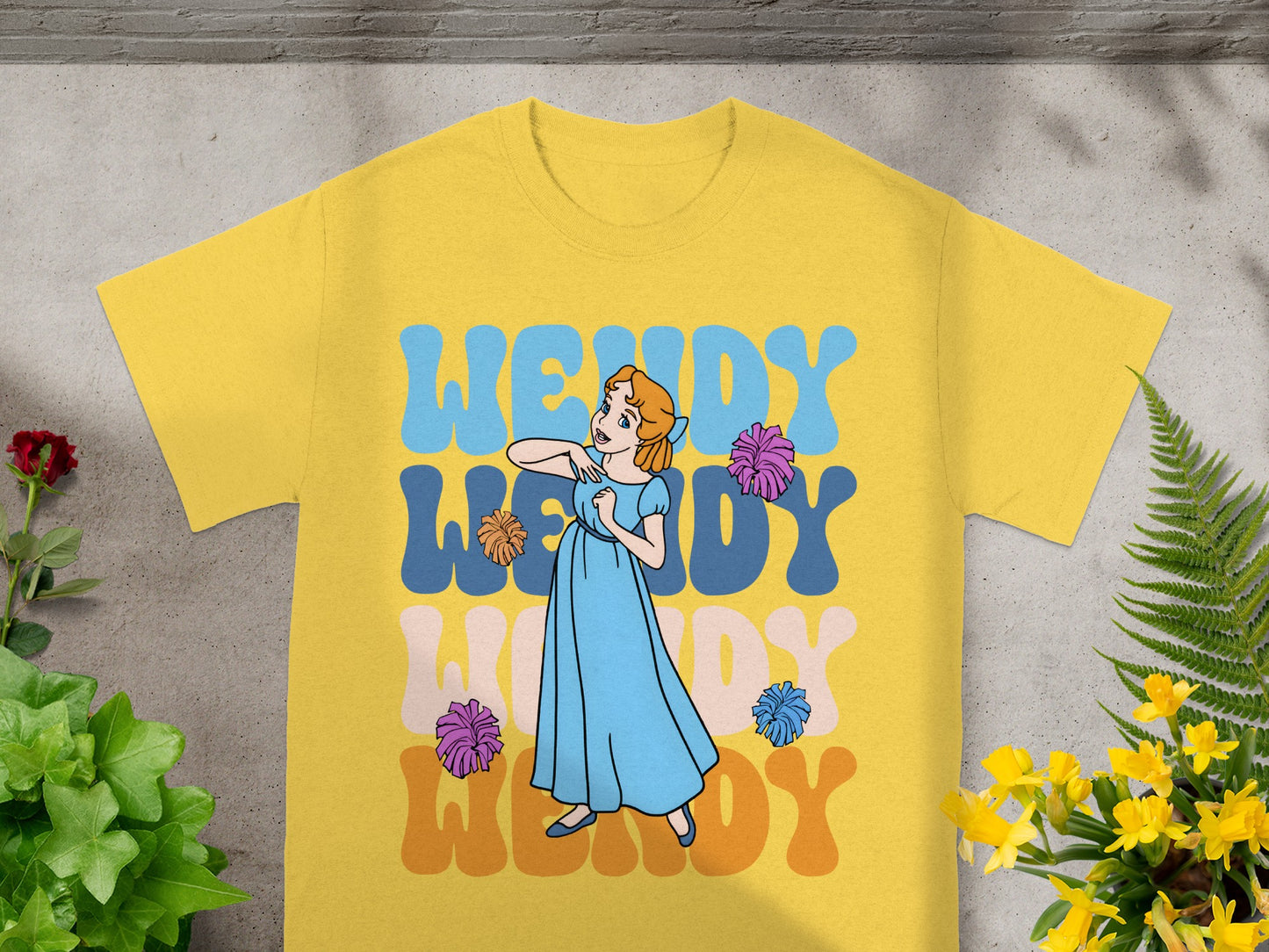 Yellow t-shirt with "Wendy" in colorful wavy letters and a cartoon girl.