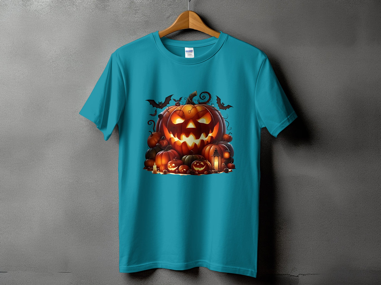 Teal t-shirt featuring a spooky Halloween pumpkin graphic with bats and lanterns.