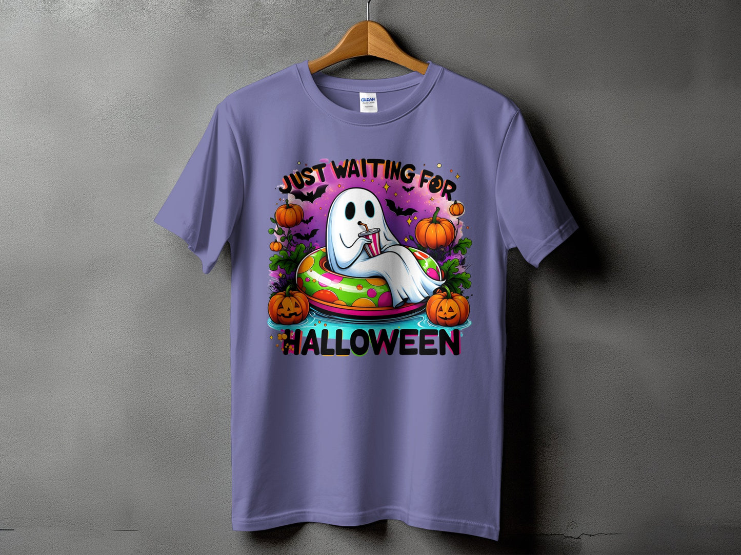 Ghost in inner tube with pumpkins and text "Just Waiting for Halloween."
