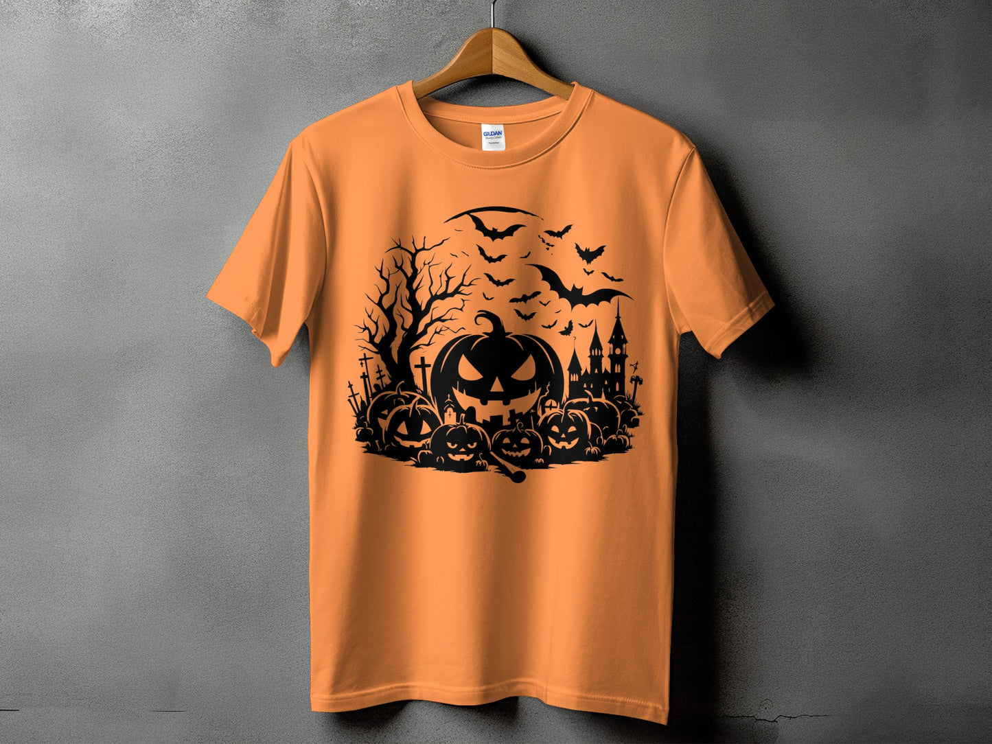 Orange t-shirt with black Halloween graphic featuring pumpkins, bats, and a haunted castle.
