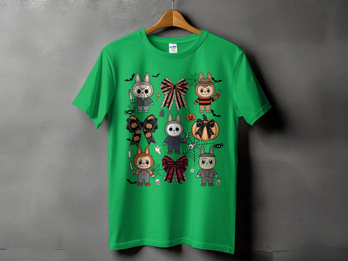 Green t-shirt featuring cartoon characters dressed as horror movie icons for Halloween.