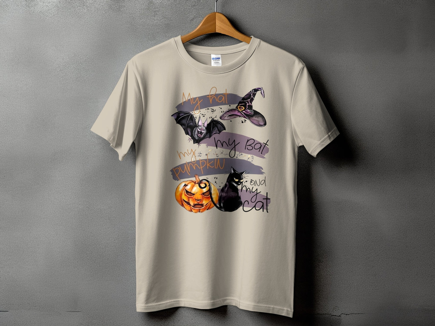 T-shirt with Halloween graphic of a bat, witch hat, jack-o-lantern, and black cat with text.