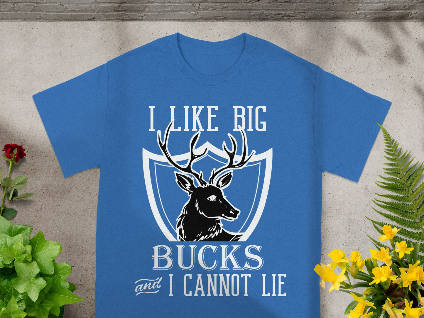 Blue t-shirt with graphic of deer and text "I LIKE BIG BUCKS and I CANNOT LIE".