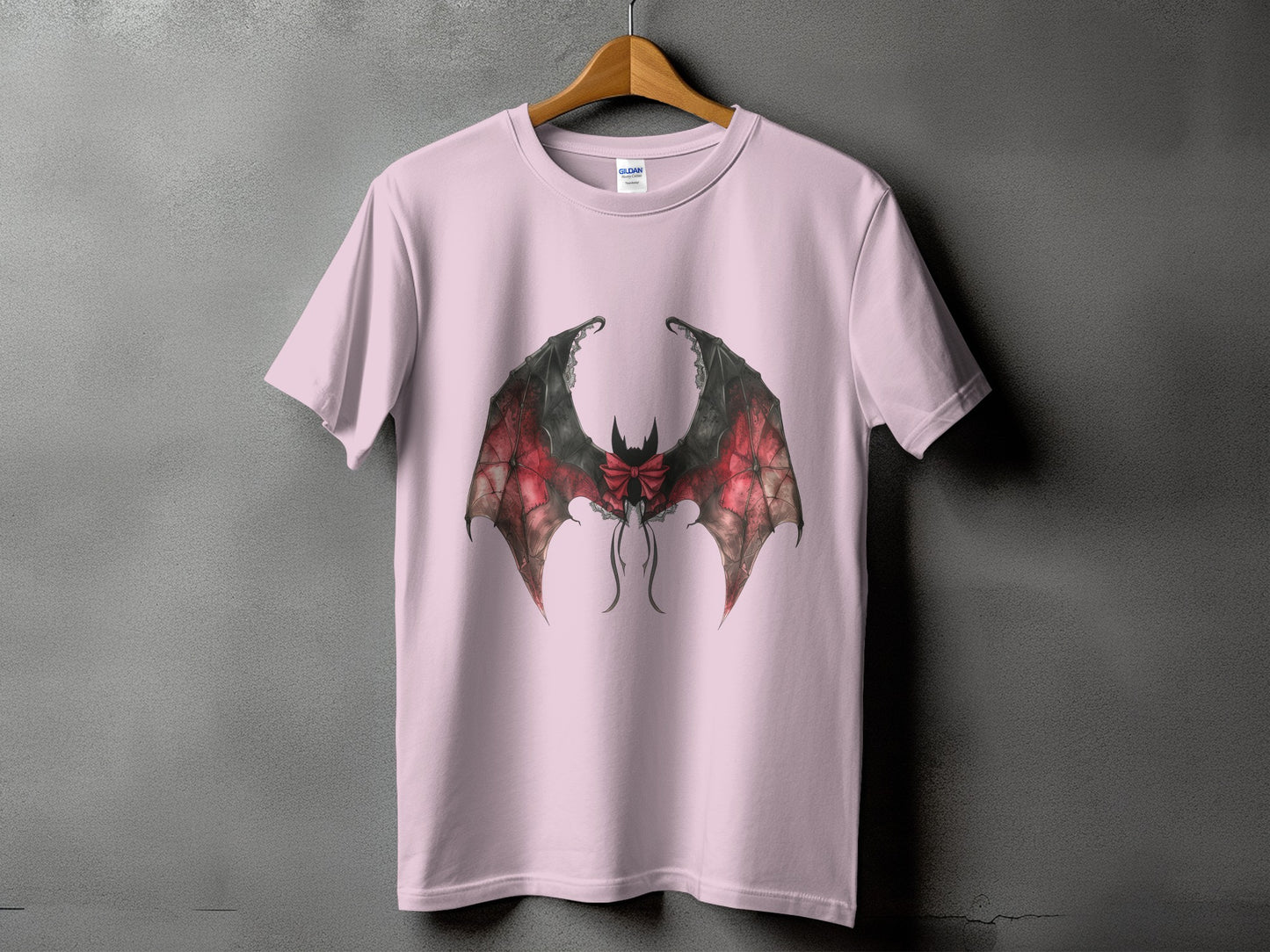 Pink t-shirt with large, detailed bat wings graphic and bow detail.