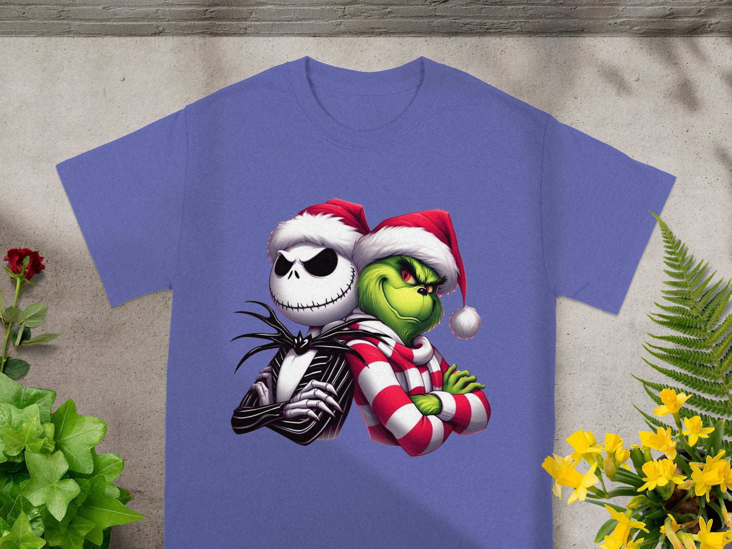 Jack Skellington and the Grinch wearing Santa hats on a purple t-shirt.