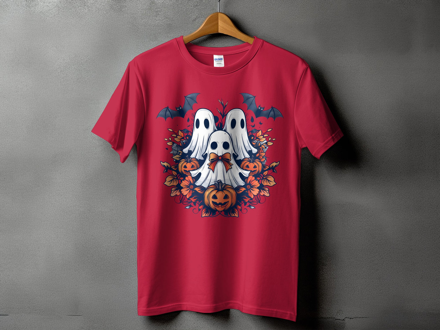 Red t-shirt with a Halloween graphic of three ghosts, pumpkins, bats, and flowers.