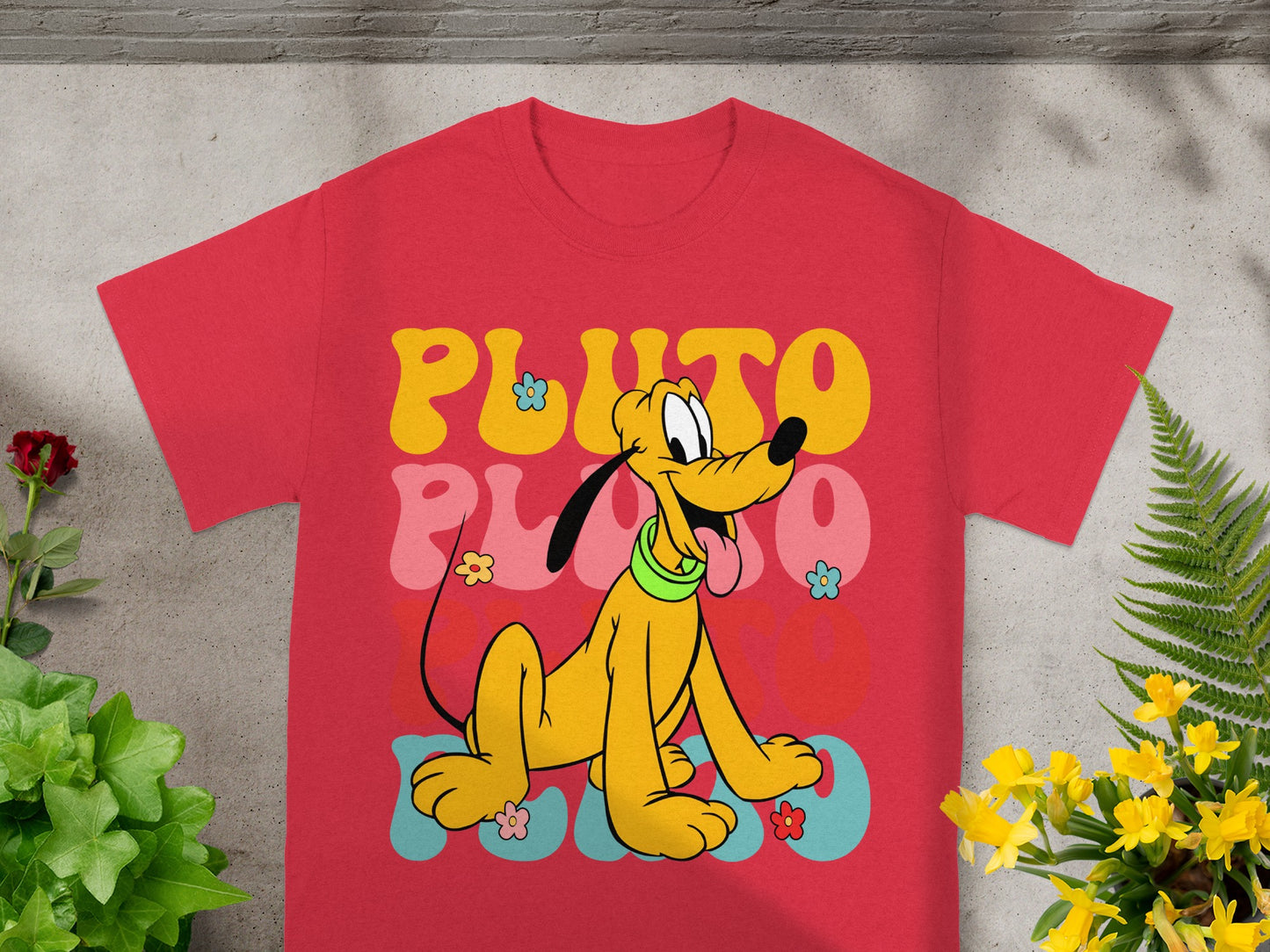 Red t-shirt with retro Pluto design and colorful "PLUTO" text.