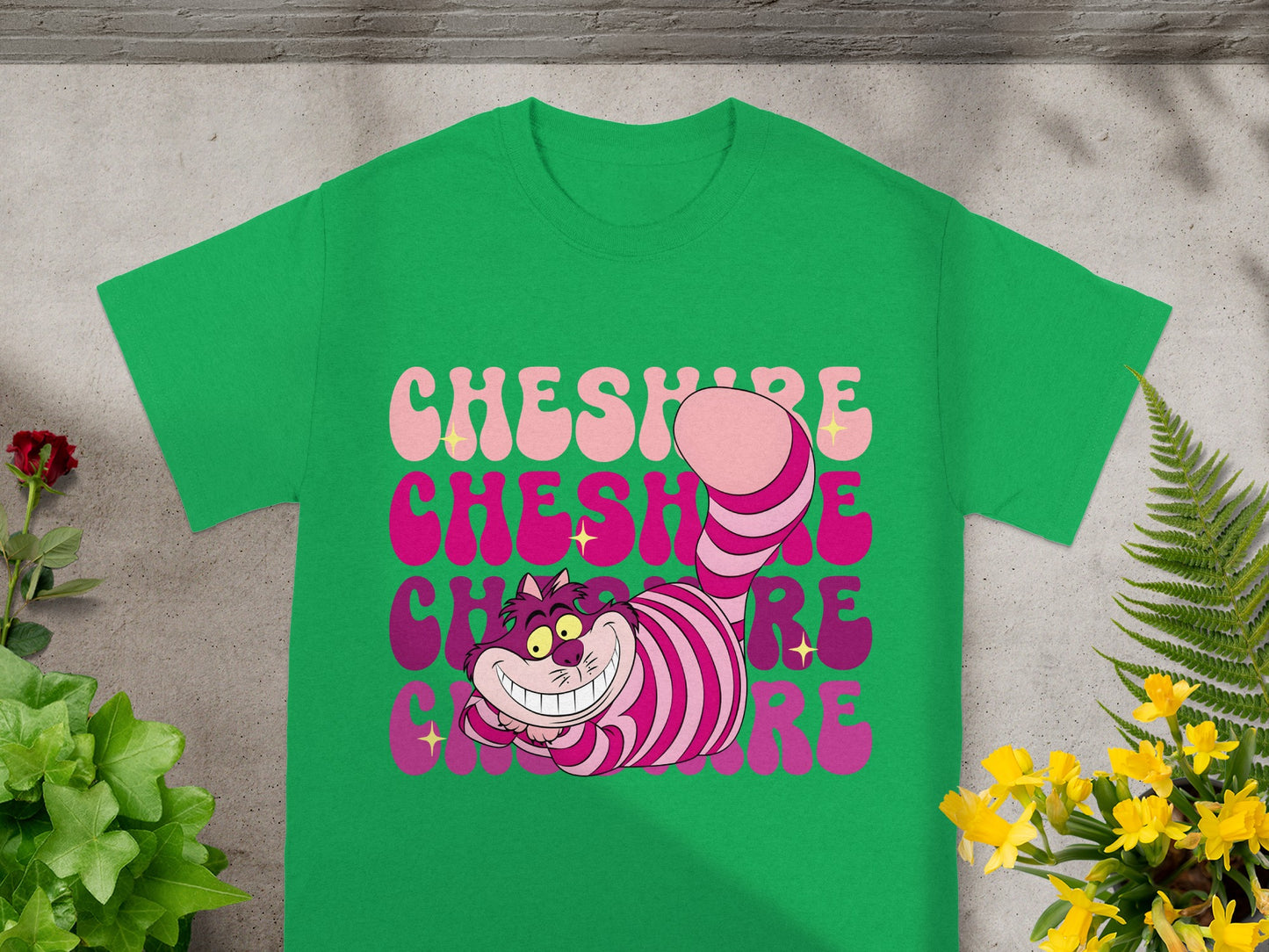 Green t-shirt with smiling Cheshire Cat and "Cheshire" text.