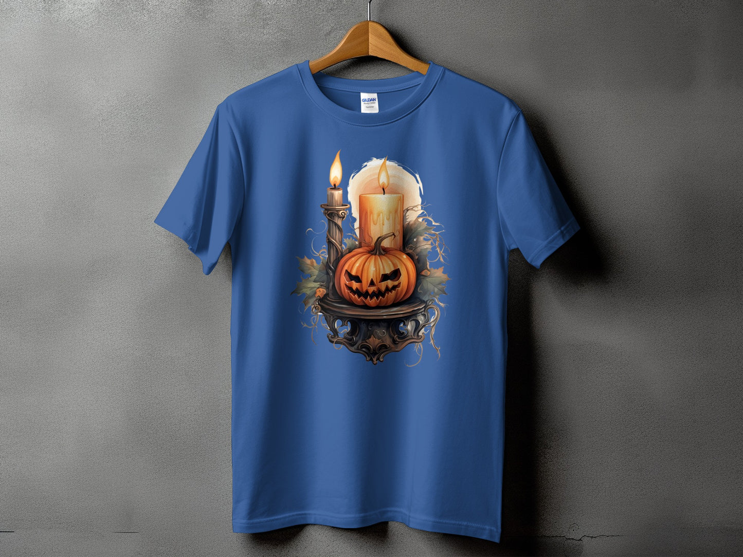 Blue t-shirt with a Halloween graphic of a jack-o'-lantern and candles.