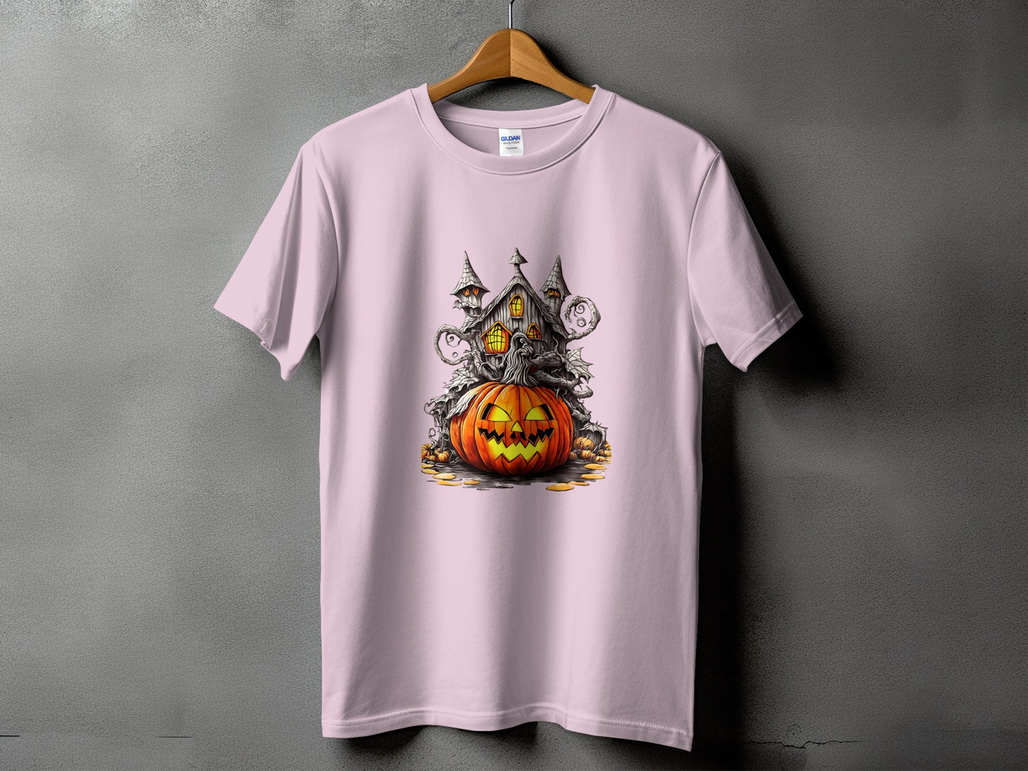 Pink t-shirt with Halloween haunted house and jack-o'-lantern graphic.