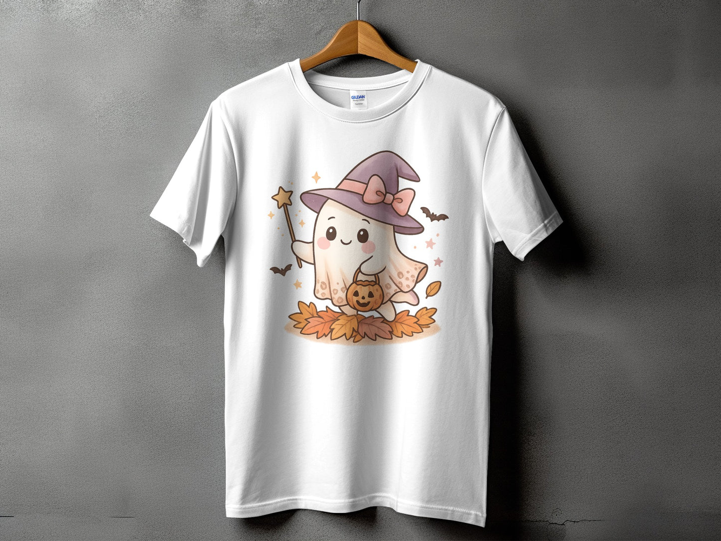 White t-shirt with a cute ghost wearing a witch hat and holding a pumpkin bucket.