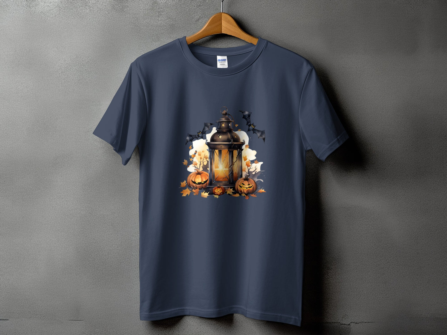 T-shirt with Halloween graphic of a lantern, pumpkins, bats, and leaves.