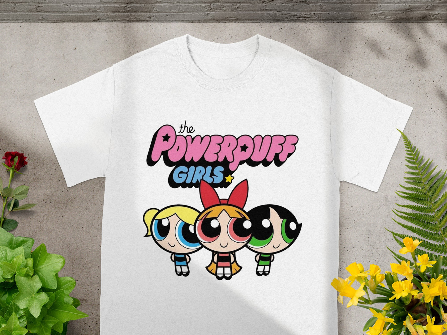 The Powerpuff Girls graphic on a white t-shirt.