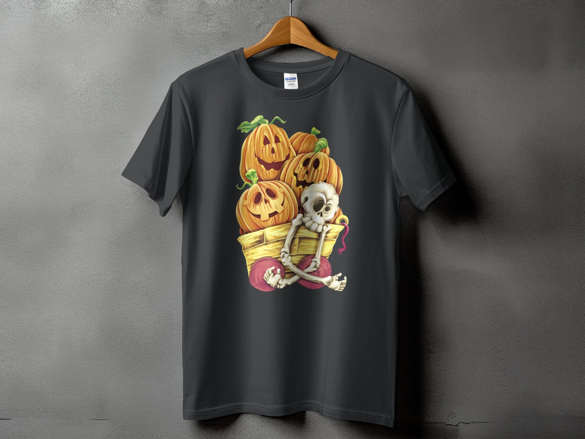 Dark grey t-shirt with Jack-o'-lanterns and skeleton in a wagon graphic.