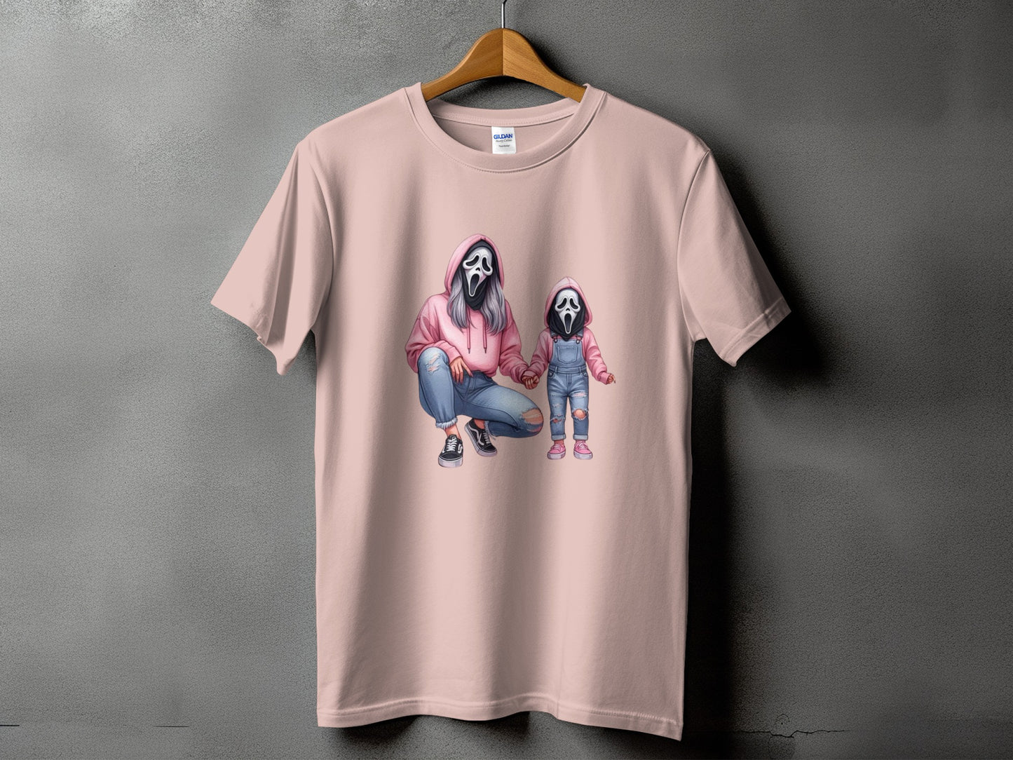Pink t-shirt with graphic of two figures in Ghostface masks, one adult and one child.