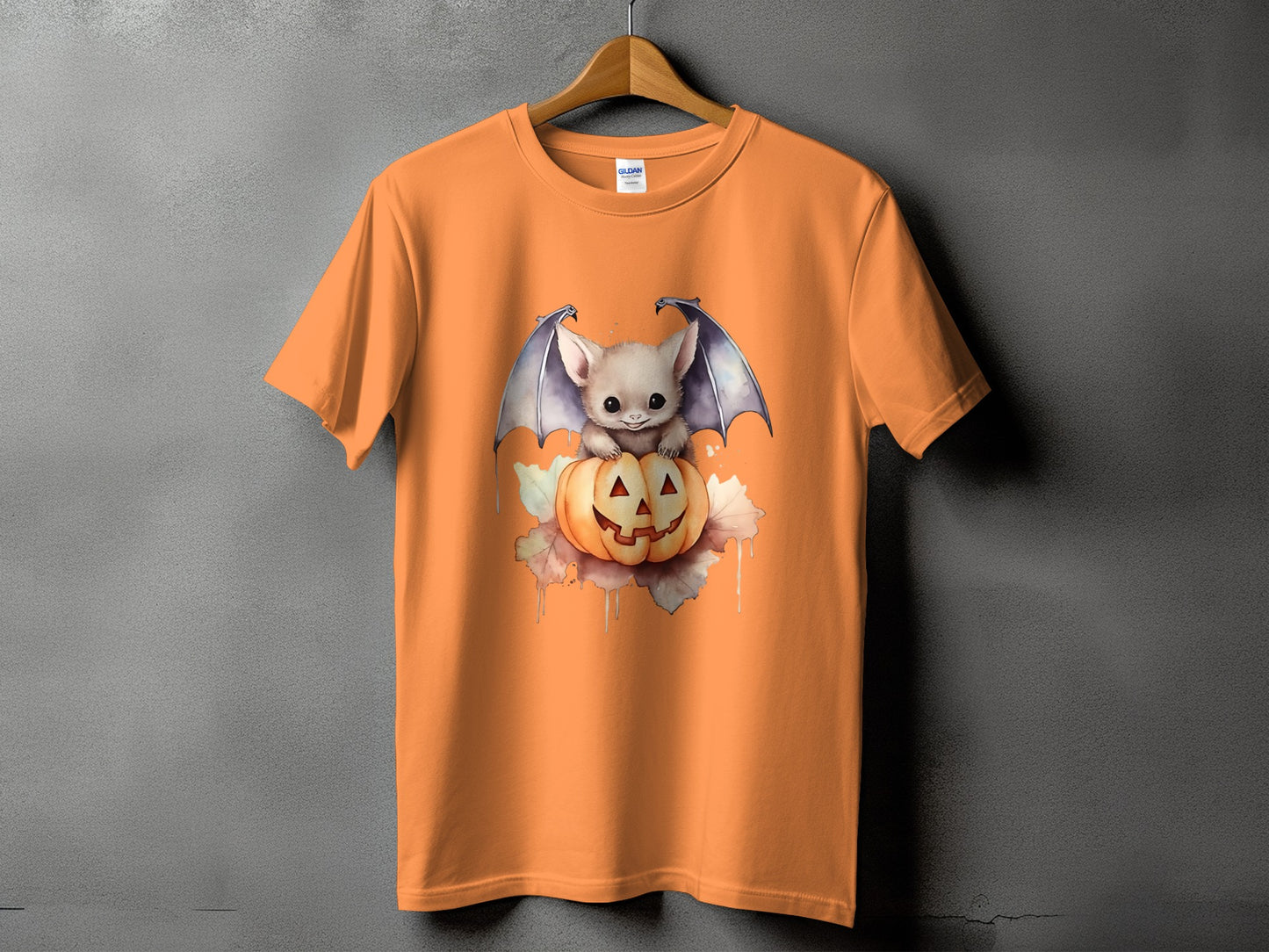 Orange t-shirt with a cute bat and jack-o'-lantern Halloween graphic.