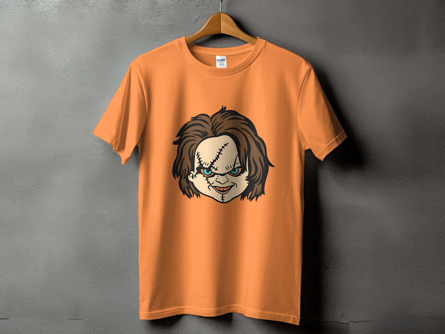 Orange t-shirt with a Chucky doll face graphic.