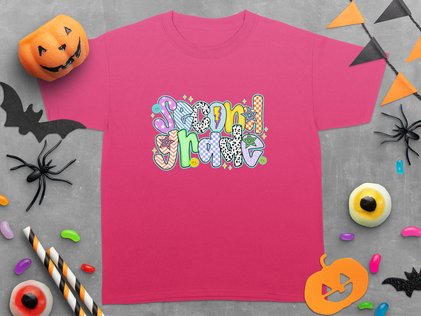 Pink t-shirt with colorful "Second Grade" text and Halloween-themed decorations.