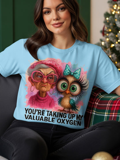 Light blue t-shirt with a cartoon owl and an elderly woman with text.