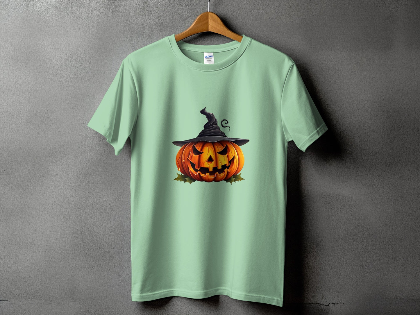 Light green t-shirt with jack-o'-lantern wearing a witch hat graphic.