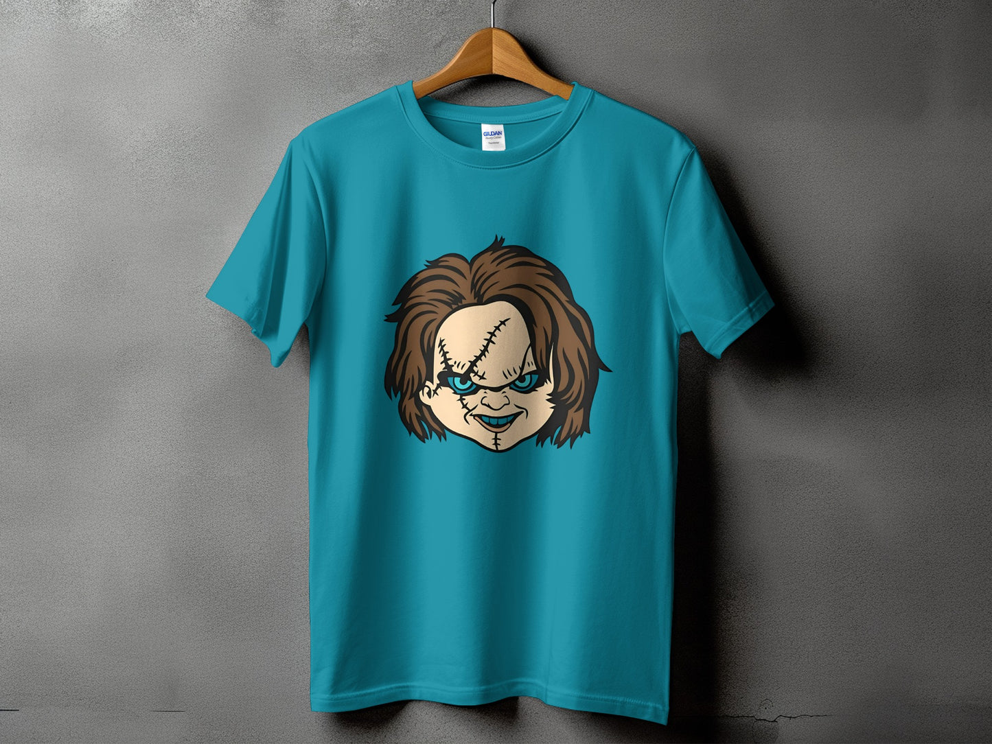 Teal t-shirt with Chucky doll face graphic and Gildan tag.