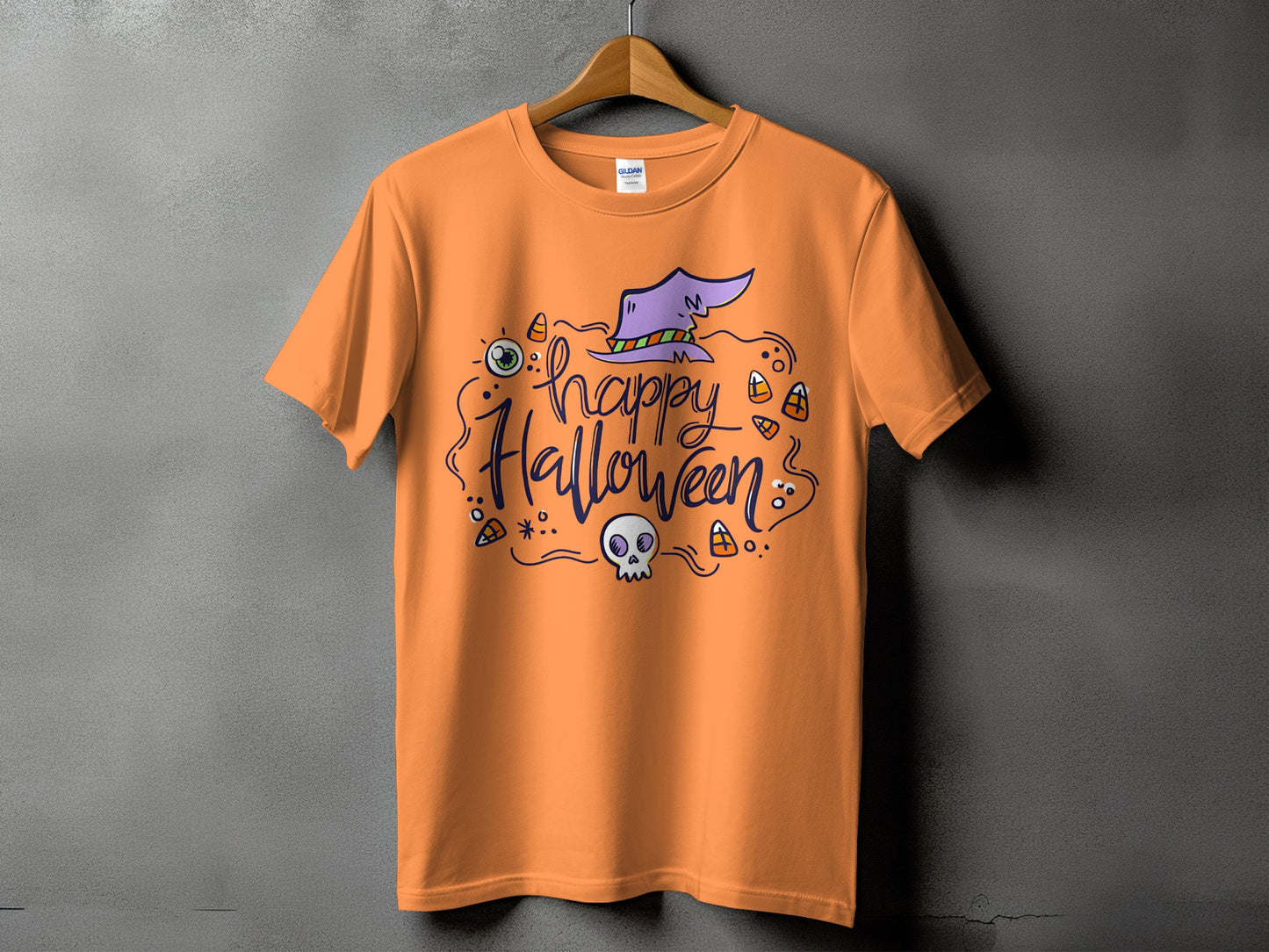 Orange t-shirt with "happy Halloween" text, a witch hat, skull, and candy corn.