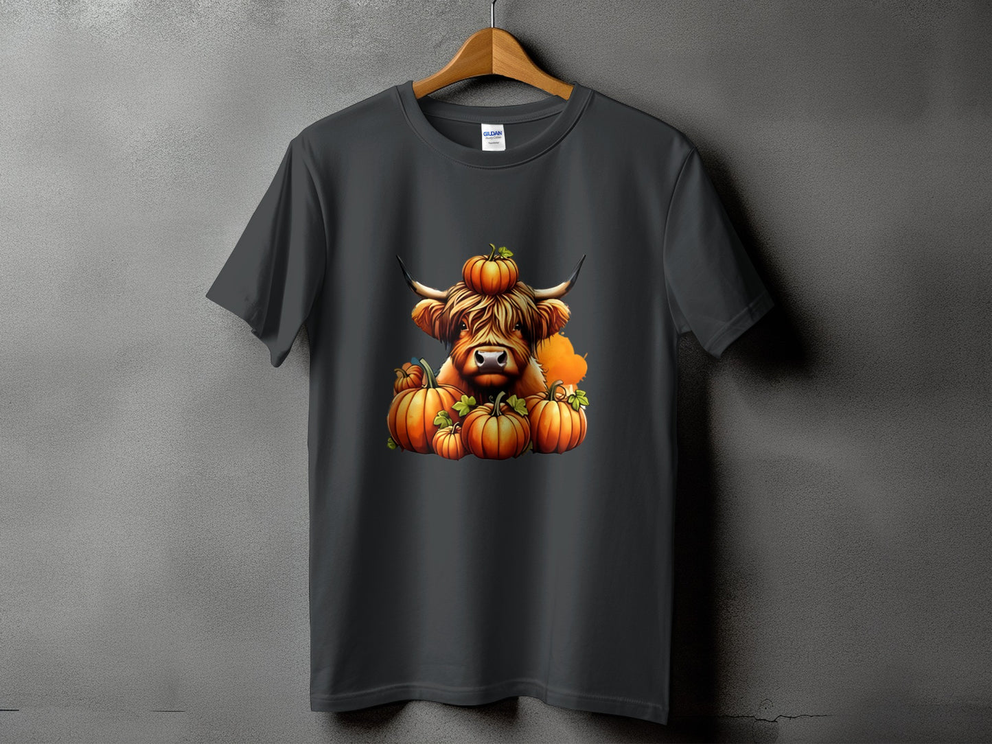 Dark gray t-shirt with Highland cow and pumpkins graphic.