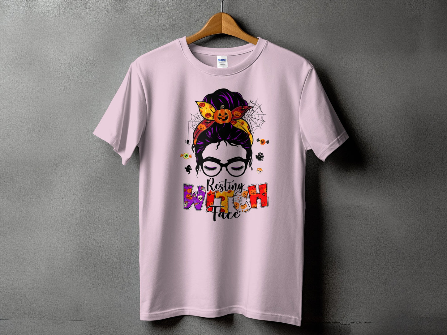 Pink t-shirt with Halloween graphic of a woman with glasses and text "Resting Witch Face".