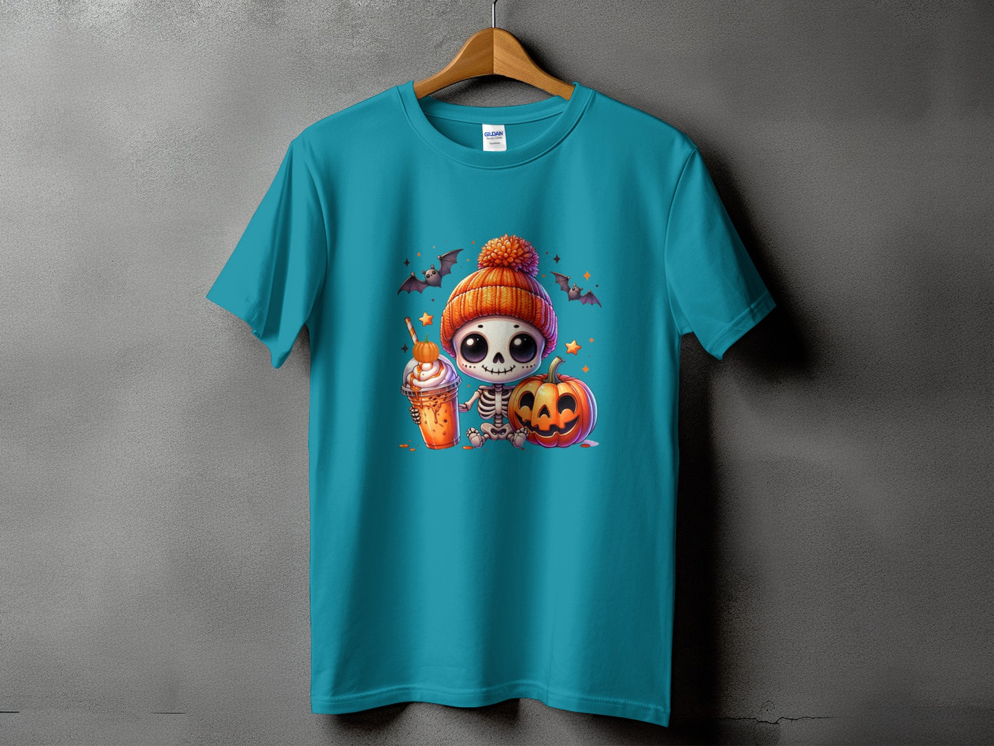 Teal t-shirt with cute skeleton, pumpkin, and Halloween drink graphic.