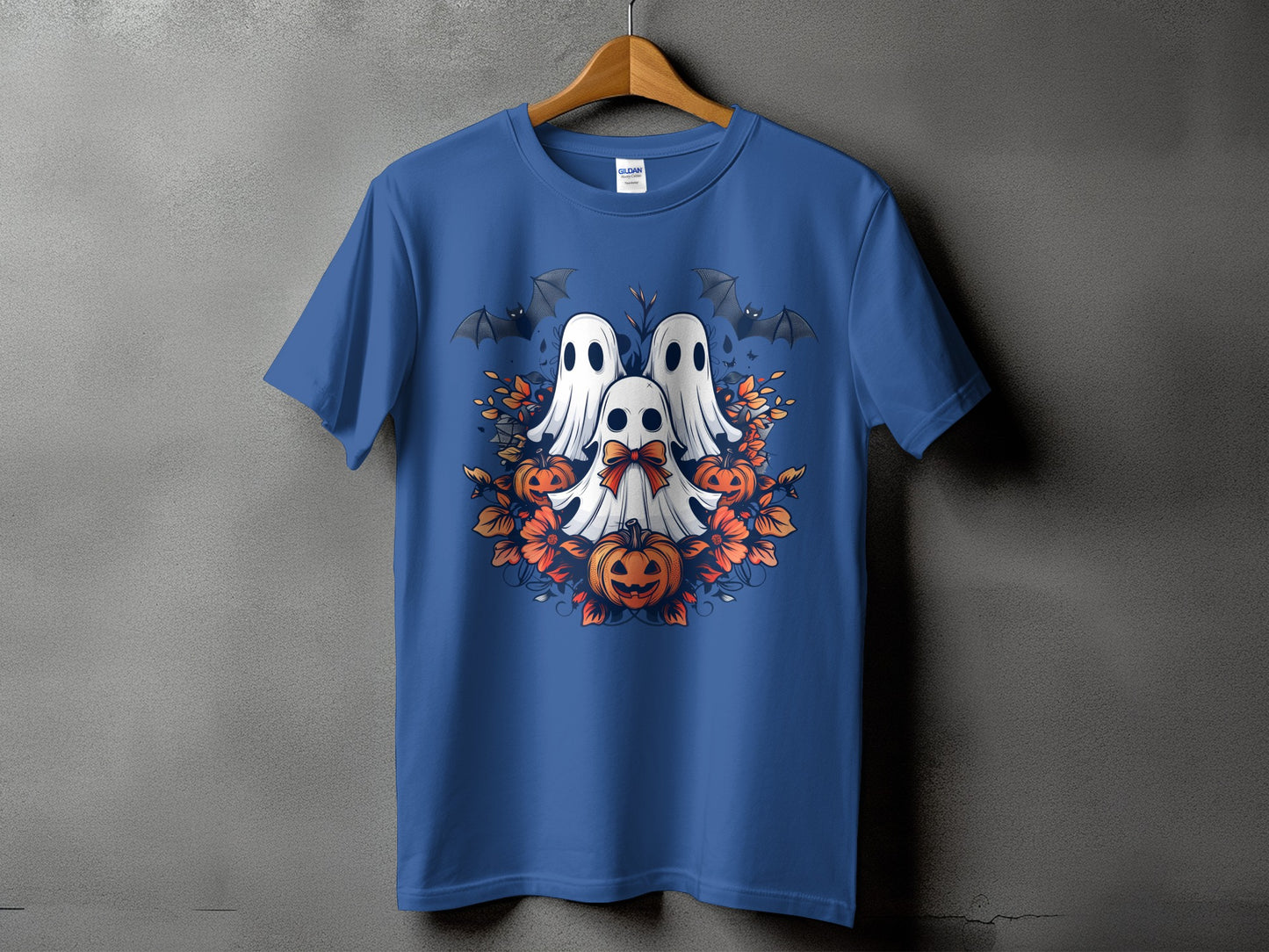 Blue t-shirt with a Halloween design of three ghosts, pumpkins, bats, and orange flowers.