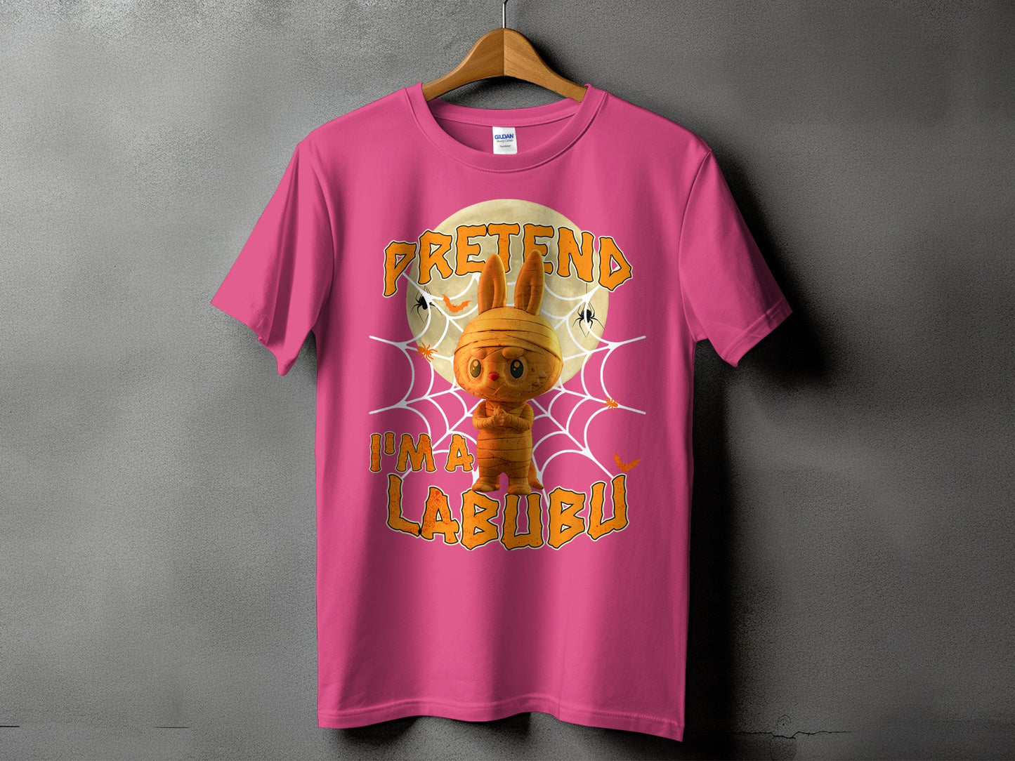 Pink t-shirt with Halloween graphic of mummy Labubu and text "PRETEND I'M A LABUBU".