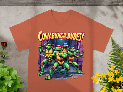 Teenage Mutant Ninja Turtles with "Cowabunga, Dudes!" text on an orange t-shirt.
