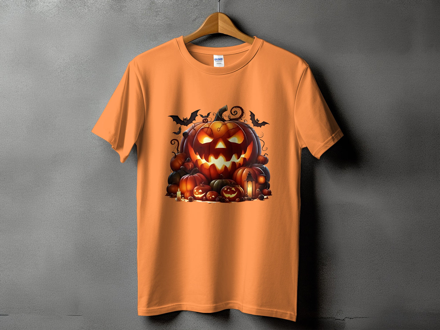 Orange t-shirt with a spooky Halloween pumpkin and bats graphic print.