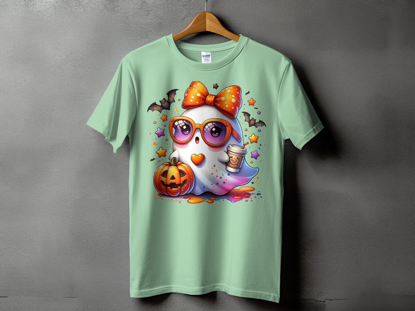 Light green t-shirt with a cute cartoon ghost, pumpkin, bats, and coffee cup.