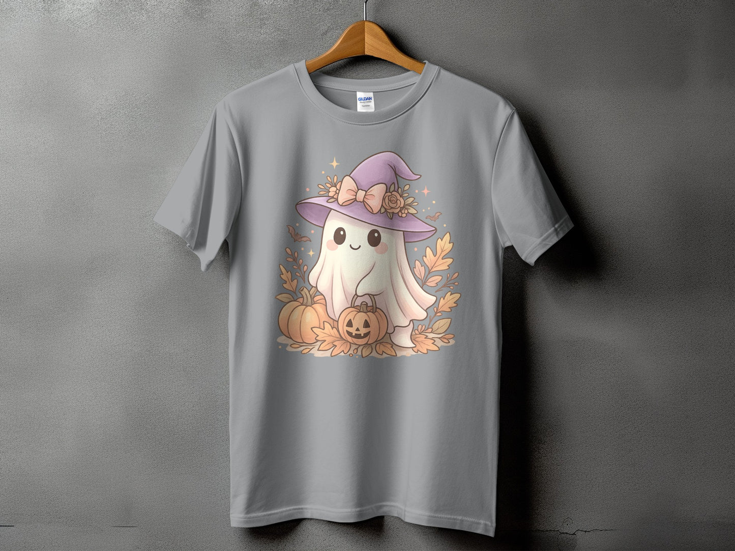 Cute ghost in a witch hat with pumpkins and fall leaves graphic on a gray t-shirt.
