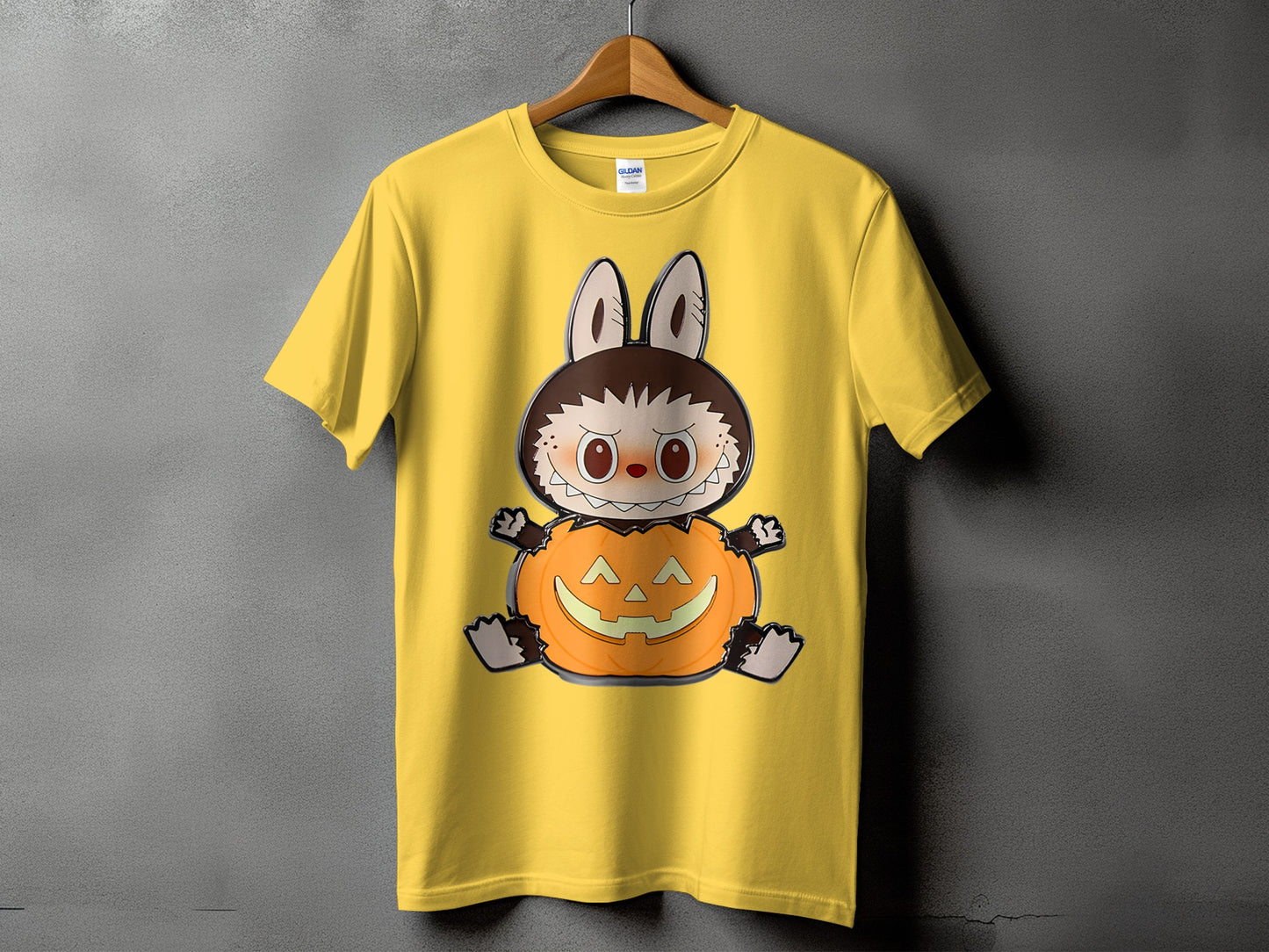 Yellow t-shirt with a cartoon character sitting in a pumpkin.