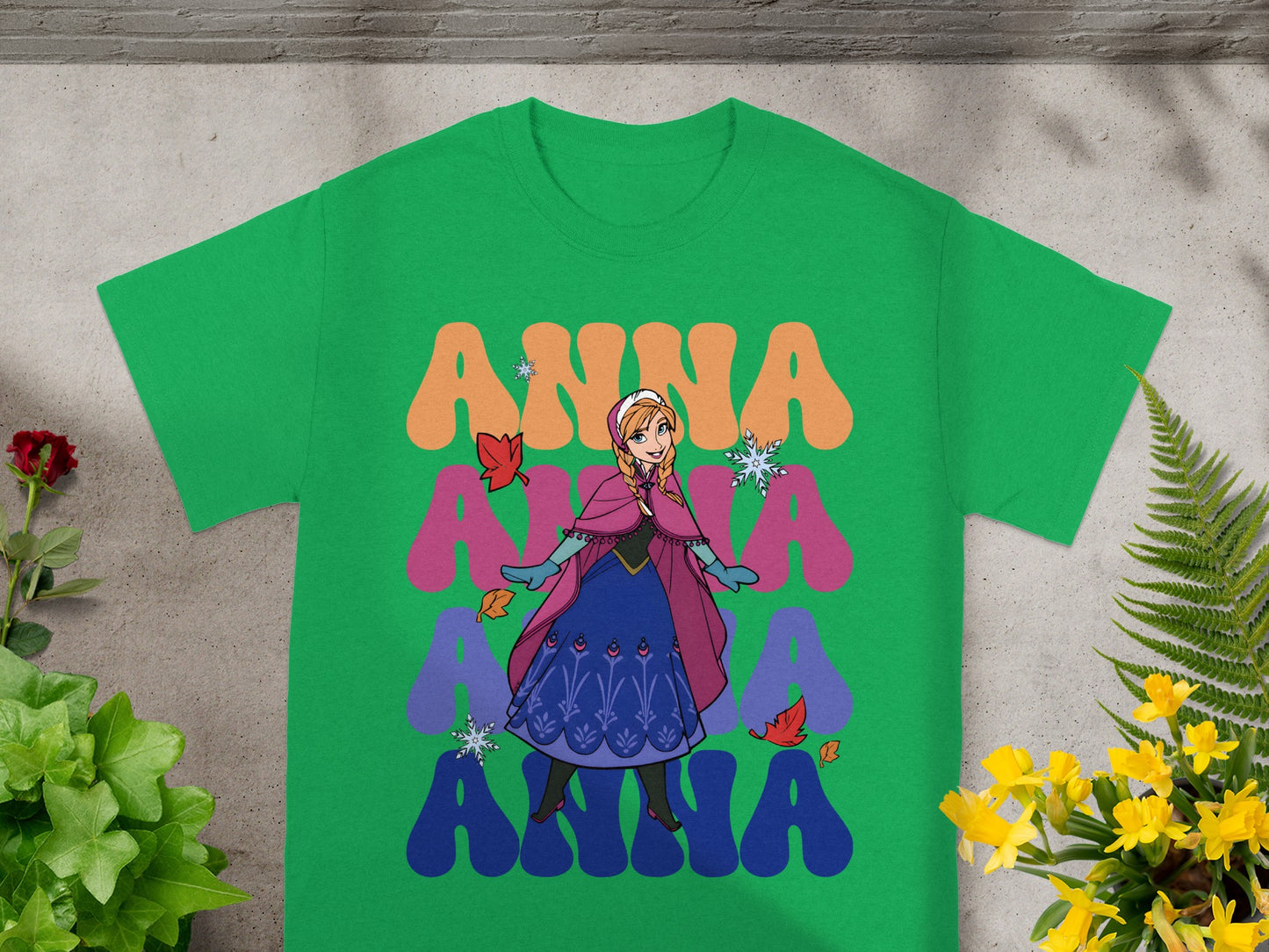 Green t-shirt with Anna from Frozen graphic and colorful "ANNA" text.