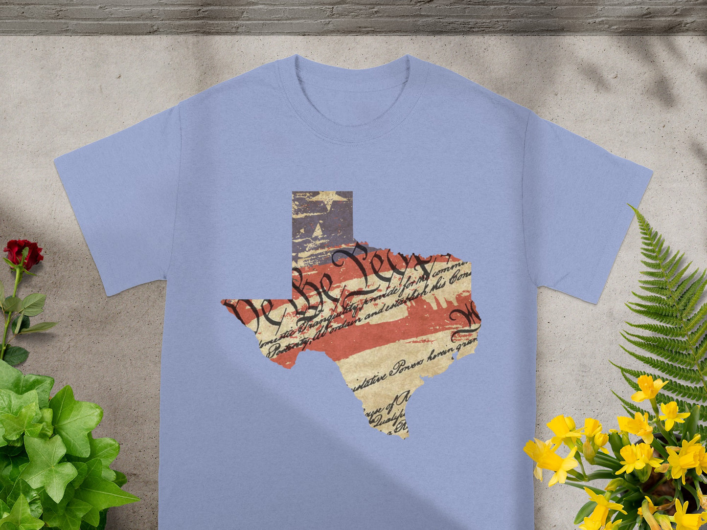 Texas map silhouette with US flag and Constitution text graphic on purple t-shirt.