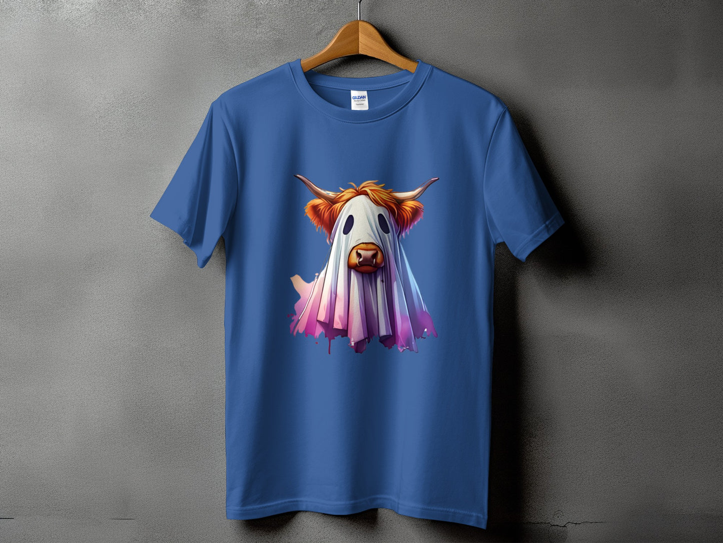 Blue t-shirt with a Highland cow dressed as a ghost graphic.
