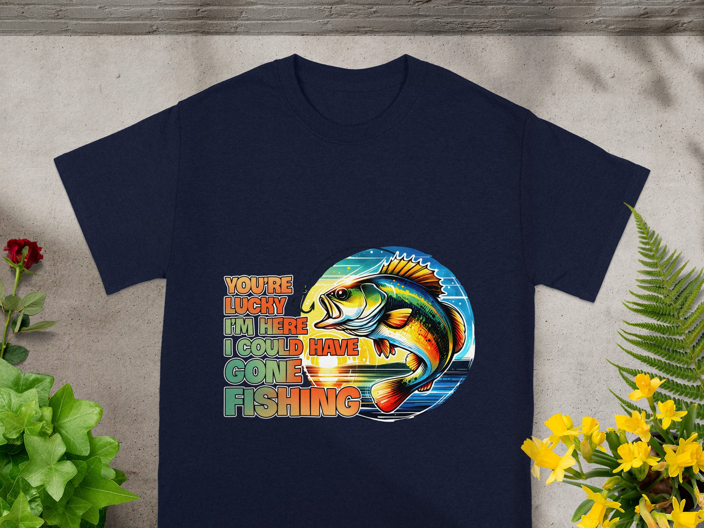 Vintage-style graphic on navy t-shirt with text "You're Lucky I'm Here I Could Have Gone Fishing" and a fish.