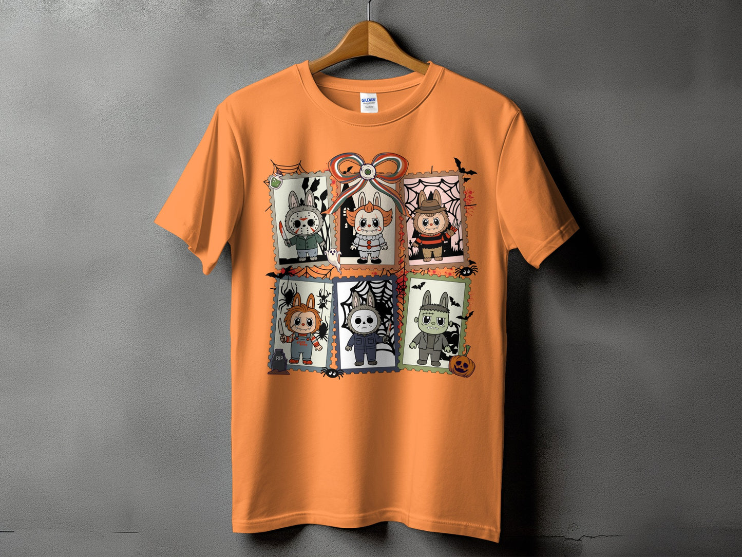Orange t-shirt featuring six Halloween-themed cartoon characters in stamp-like frames.