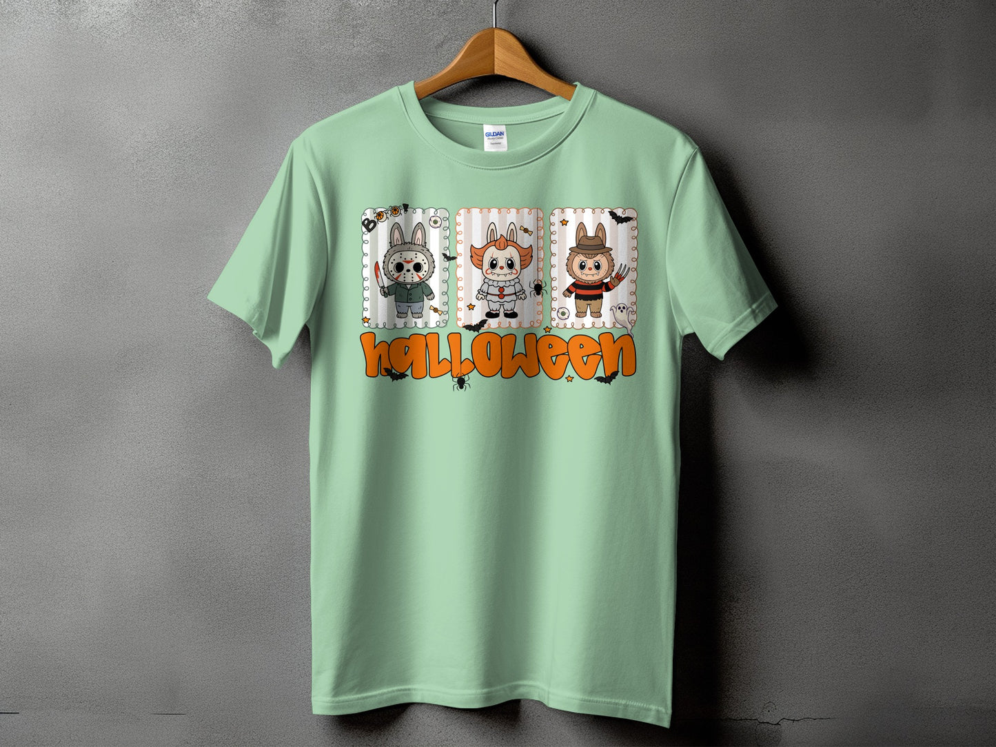Mint green t-shirt with Halloween characters and text.