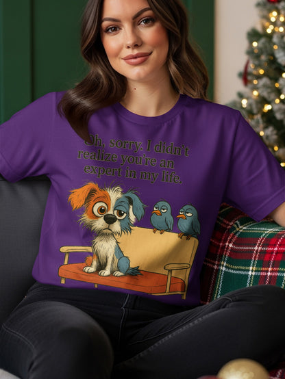Purple t-shirt with cartoon dog and birds and "Oh, sorry. I didn't realize you're an expert in my life."