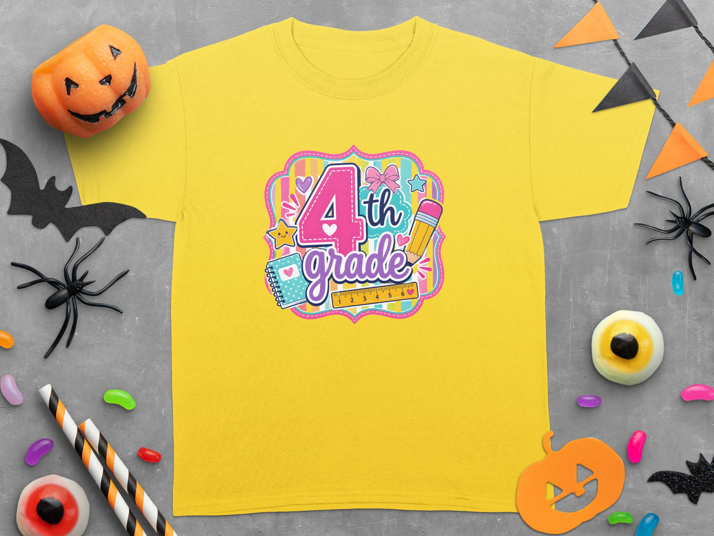 Yellow t-shirt with "4th grade" graphic featuring a ruler, pencil, and celebratory elements.