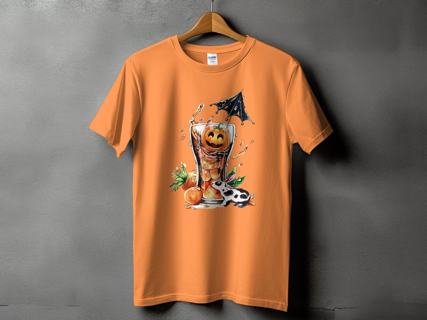 Orange t-shirt with a Halloween graphic of a jack-o'-lantern drink and a Dalmatian rabbit.